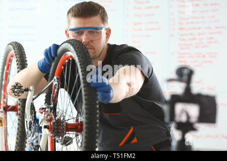 Portrait jeune homme la réparation de vélo à l'atelier Banque D'Images