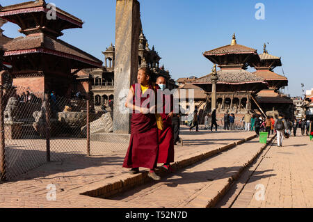 Katmandou, Népal - 28 décembre 2015 : les moines bouddhistes dans l'usure traditionnelle marche ensemble à Patan Durbar Square. Banque D'Images