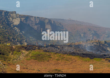 UK Moorland Fire : Ilkley Moor, West Yorkshire, Royaume-Uni. 21 avril 2019. Poursuivre les efforts des pompiers pour éteindre le feu, travaillant la nuit pour surveiller et combattre les flammes. Ici, une section de forêt en vertu de Rocky Valley encore bien fumer. Rebecca Cole/Alamy Live News poursuivre les efforts pour éteindre le feu, travaillant la nuit pour lutter contre les flammes. Longueurs de flexible d'eau de transporter l'eau jusqu'à l'emplacement de l'incendie. Rebecca Cole/Alamy Live News Banque D'Images