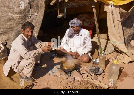 Les hommes de préparer un repas à l'extérieur de leur tente de fortune au cours de l'assemblée annuelle du festival de l'élevage à Nagaur, Rajasthan, en Inde. Banque D'Images