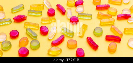 Assortiment de bonbons de gelée sur un fond de couleur jaune, vue rapprochée. Kids Birthday party concept Banque D'Images