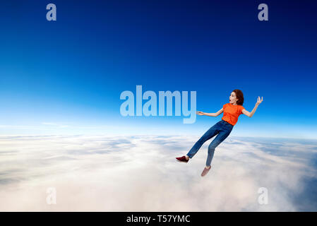 Jeune femme rousse et pas tomber dans la mer de nuages. Banque D'Images