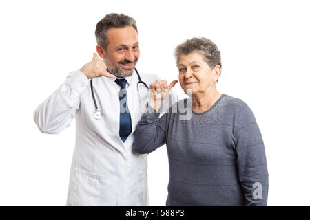 Friendly male medic et patiente âgée holding doigts près oreille comme appel concept isolated on white background studio Banque D'Images