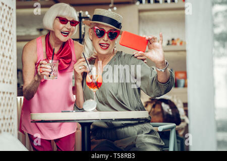 Les femmes gaies Nice assis dans le café ensemble Banque D'Images