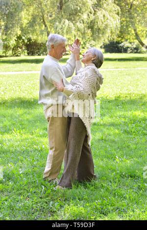 Portrait of senior couple dancing in autumn forest Banque D'Images