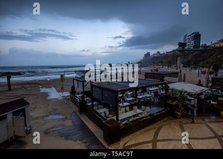 Plage de sable fin lors d'un lever du soleil orageux à Netanya, en Israël. Banque D'Images