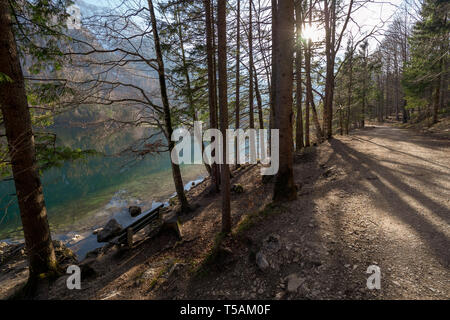 Banc en bois vide sur la côte des Vorderer Langbathsee près d'Ebensee, OÖ, l'Autriche, avec le grand paysage reflétant sur l'eau cristalline Banque D'Images