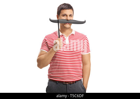 Young handsome man holding moustache sur un bâton plus de bouche isolé sur fond blanc Banque D'Images