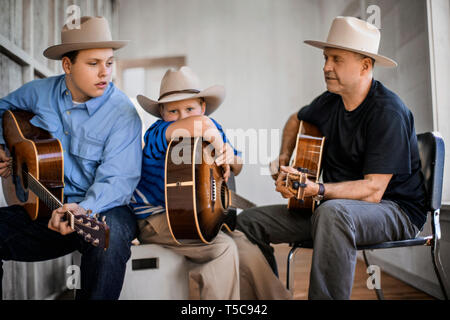 Le père et ses deux fils à jouer de la guitare ensemble. Banque D'Images