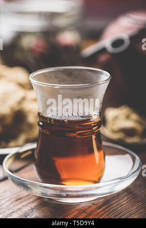 Armudu verre avec le thé noir avec des ustensiles de cuisine sur l'arrière-plan Banque D'Images