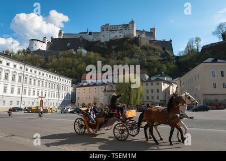 La ville de Salzbourg en Autriche, en vue d'une balade en calèche en passant par Kapitelplatz avec vue sur le château au sommet d'une colline(Festung Hohensalzburg), Salzbourg. Banque D'Images