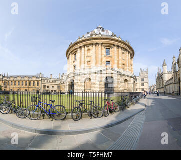 Les vélos enchaînés à des garde-corps à la Radcliffe Camera, une partie de la bibliothèque bodléienne complexe à l'université d'Oxford, Angleterre, lors d'une journée ensoleillée. Banque D'Images