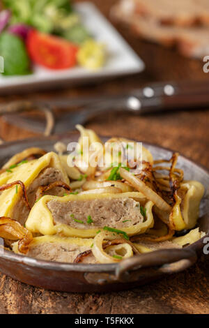 Maultasche souabe avec les oignons dans une casserole Banque D'Images