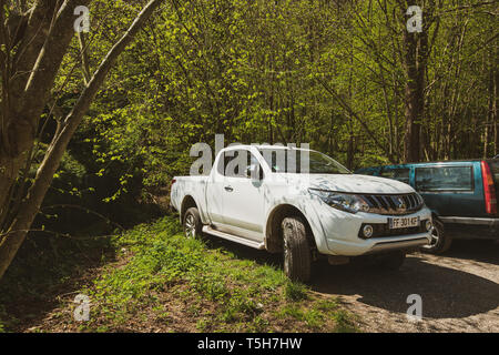 Ribeauvillé, France - Apr 19, 2019 : Pick-up blanc Mitsubishi et Volvo voitures garées dans le parking de la forêt Banque D'Images