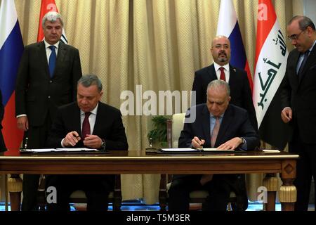 Bagdad. Apr 25, 2019. Le Ministre iraquien des affaires étrangères, Mohammed al-Hakim (R, à l'avant) et la visite de vice-premier ministre russe, Iouri Borissov (L,) avant de signer l'accord commercial à Bagdad, l'Iraq, le 25 avril 2019. Ministère iraquien des affaires étrangères a déclaré jeudi que l'Irak et la Russie ont signé un certain nombre d'accords et de protocoles d'entente (PE) dans divers domaines. Source : Xinhua/Alamy Live News Banque D'Images