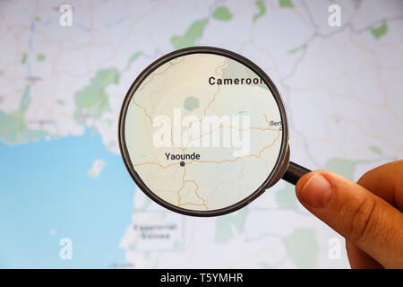Yaoundé, Cameroun. Une carte politique. Concept d'illustration de visualisation de la ville sur l'écran grâce à une loupe dans la main. Banque D'Images