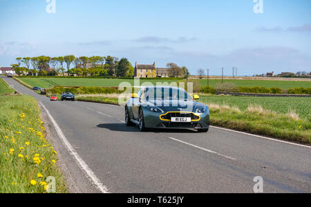 East Lothian, UK. 28 avril 2019. Voiture Classique Tour : North Berwick Rotary Club organise son 3ème rallye avec 65 voitures inscrites. La voiture parcours est de East Lothian et retourner par le Scottish Borders, la collecte de fonds pour les organismes de bienfaisance locaux. Une voiture de sport Aston Martin 2016 sur une route de campagne Banque D'Images