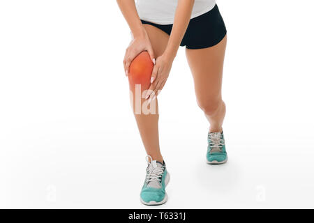 Femme portant des vêtements de sport souffrant de douleurs dans le genou. Close-up du genou douloureux Banque D'Images