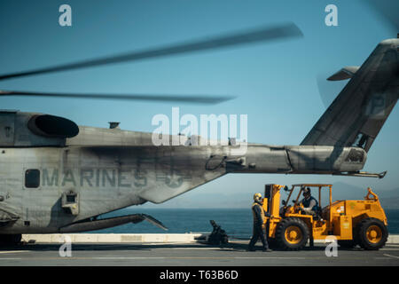 190330-M-HB658-0017 de l'OCÉAN PACIFIQUE (30 mars 2019) Les Marines américains et les marins charger des cargaisons dans un CH-53E Super Stallion moyen maritime avec l'escadron à rotors basculants (VMM) 163 (renforcée), 11e Marine Expeditionary Unit (MEU), à bord de la classe San Antonio-dock transport amphibie USS John P. Murtha (LPD 26). Les Marines et les marins du 11e MEU mènent des opérations de routine dans le cadre du groupe amphibie Boxer dans l'océan Pacifique. (U.S. Marine Corps photo par le s.. Donald Holbert) Banque D'Images