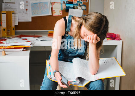 Fatiguée, stressée female college student studying Banque D'Images