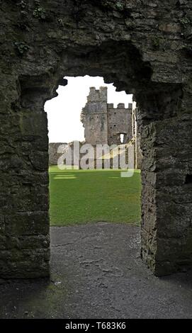 Vue à travers une porte médiévale voûtée en pierre au château de Pembroke, West Wales Banque D'Images