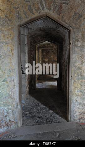 Vue à travers une porte médiévale voûtée en pierre au château de Pembroke, West Wales Banque D'Images