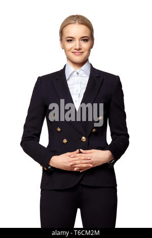 Portrait de jolie blonde en tenue d'affaires se tient avec les mains pliées. Banque D'Images