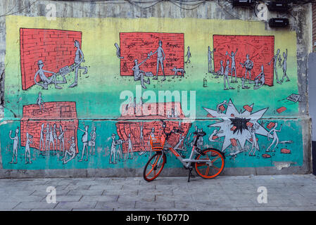 Mobike location de Smart Bike Partager système à côté mur de Fabrica de Tabacos bâtiment industriel de l'ancienne usine de tabac à Madrid, Espagne Banque D'Images