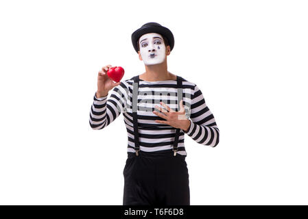 Holding Mime cœur rouge isolé sur fond blanc Banque D'Images