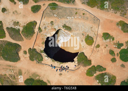 VUE AÉRIENNE. Algar de Benagil: Une grande grotte de mer photogénique sur la côte déchiquetée de la région de l'Algarve. Lagoa, Portugal. Banque D'Images