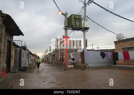 Johannesburg, Afrique du Sud. 22 avr, 2019. Un homme marche dans la boue du township d'Alexandra à Johannesburg. L'Afrique du Sud tient sa sixième élections démocratiques le 8 mai. (Pour 'dpa pour le Jubilé, il y a une gueule humeur : Afrique du Sud élit un nouveau parlement' à 03.05.2019) Crédit : Kate Bartlett/dpa/Alamy Live News Banque D'Images