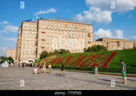 Colline Poklonnaya, Kutuzovsky Prospekt avec bâtiments résidentiels et de 'Moscow' écrit en rouge des fleurs sur un après-midi ensoleillé en été. Moscou, Russie. Banque D'Images