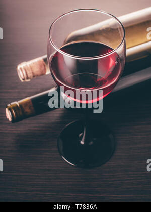 Les bouteilles de vin glasse et sur un fond de bois Banque D'Images