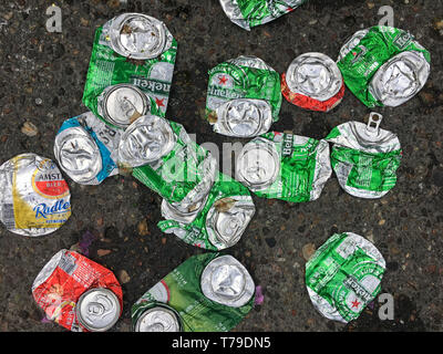 De nombreuses boîtes de bière vides en aluminium sont écrasées jonchant une rue de la ville d'Amsterdam. Banque D'Images