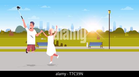 Jeune couple à l'aide de bâton selfies taking photo sur smartphone caméra homme woman having fun city parc urbain paysage lever du soleil plein d'arrière-plan Illustration de Vecteur