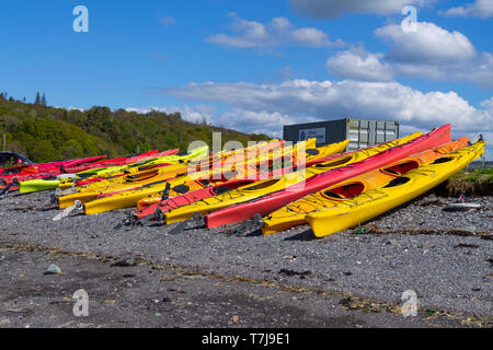 Rangées de kayaks tiré sur une plage de galets après un jours de canotage Banque D'Images