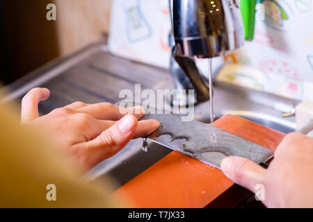 Femme chef professionnel mains le couteau pour aiguiser aiguiser sur.premium professional stone du Japon.l'affûtage avec sha traditionnels Banque D'Images