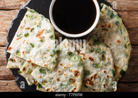 Oignon vert Les crêpes sont un savoureux pain plat chinois simplement faite avec de la farine, eau, sel, et échalotes hachées gros plan sur un conseil. Vie supérieure horizontale Banque D'Images