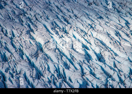 La Knik Glacier en Alaska. Manque de neige exposer les cendres retombées de la redoute à proximité de volcan, la réduction de l'effet albédo. Il y a des milliers de glaciers en Alaska, et au moins 616 d'entre eux sont nommés. Ensemble, ils sont en train de perdre 75 milliards de tonnes de glace chaque année en raison de la fonte. Ce chiffre est susceptible d'augmenter dans les années à venir. Mai 2015 a été la plus chaude en 91 ans. La couleur bleue est naturellement produit, mais est renforcé par underexposing l'image. Banque D'Images