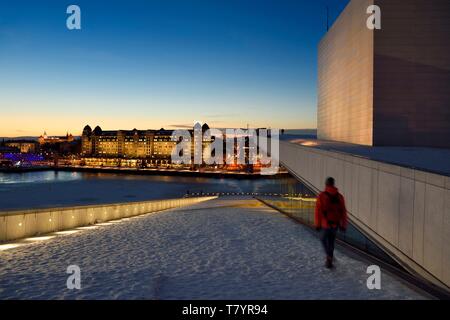 La Norvège, Oslo, zone portuaire de Bjorvika, l'opéra sous la neige, conçu par le cabinet d'architectes Snohetta Tarald Lundevall, y compris l'Havnelageret bâtiment en arrière-plan Banque D'Images