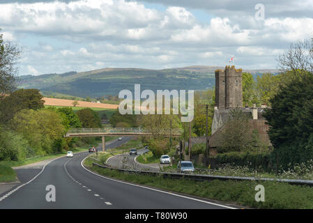 Doyen, dans le sud du Devon, Angleterre, Royaume-Uni. Mai 2019. L'autoroute A38 Devon et l'église St George Marty dominé par le Parc National de Dartmoor. Banque D'Images