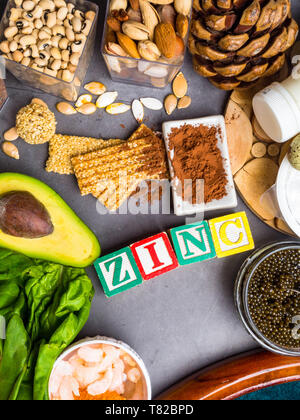 Les aliments avec le zinc minéral sur table béton gris. Vue d'en haut Banque D'Images