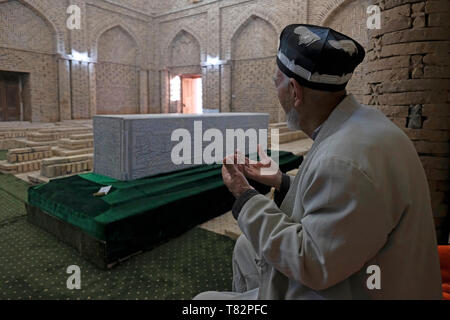 Prier à l'intérieur de l'adorateur musulman mausolée de l'ouest du complexe du Sultan Saodat, qui a été formé entre le 11ème et 17ème siècles, et a les tombes de la dynastie de Sayyid de Termez réclamé de descendance directe du prophète de l'islam, Muhammad situé dans la périphérie de Termez moderne, Surkhandarya ou région Surxondaryo en Ouzbékistan Banque D'Images