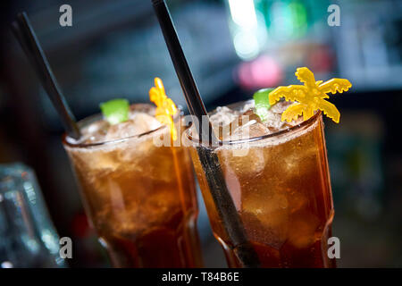 Cocktail froid sombre sur un arrière-plan flou avec bokeh. Banque D'Images