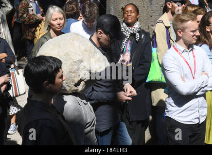 10 mai 2019, l'Italie, Venise : Natascha Süder Happelmann (2e de gauche), l'artiste, avec une sculpture sur sa tête, se tient entre de nombreux visiteurs au pavillon allemand à la Biennale de Venise 2019 Art. L'exposition internationale d'art débute le 11.05.2019 et prend fin le 24.11.2019. Photo : Felix Hörhager/dpa Banque D'Images