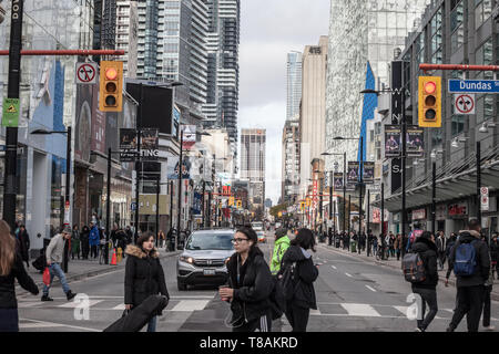 TORONTO, ONTARIO - Le 13 novembre 2018 : Gratte-ciel sur la rue Yonge, on Yonge Dundas Square, avec des personnes qui traversent sur un trottoir, les magasins et boutiques, dans un Banque D'Images