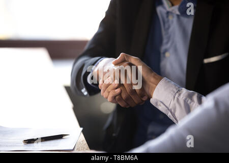 Close up of young woman shaking hands with client Banque D'Images