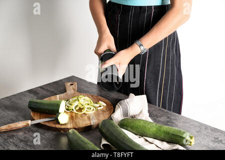 Femme faisant spaghetti de courgettes sur table de cuisine Banque D'Images