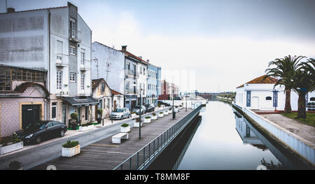 Aveiro, Portugal - Mai 7, 2018 : vue sur les maisons entourant un canal avec des reflets dans le centre historique de la ville un jour de printemps Banque D'Images