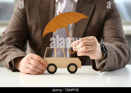 Business man in suit holding umbrella Banque D'Images